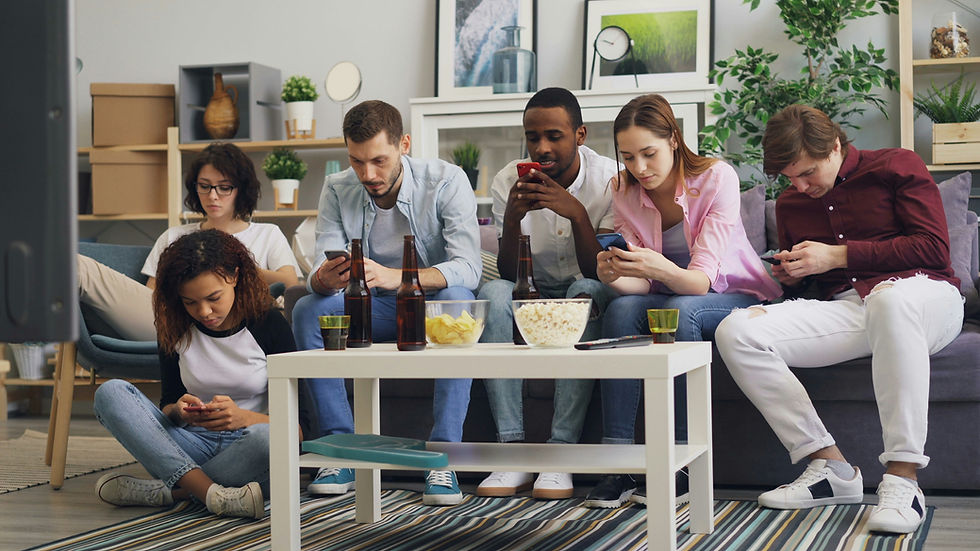 Group of people sitting together all looking at their phones, ignoring each other