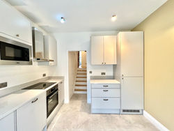 Sleek kitchen with minimalist cabinetry, stainless steel appliances, and a clean, modern design