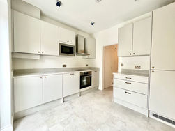 Sleek kitchen with minimalist cabinetry, stainless steel appliances, and a clean, modern design