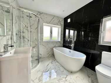 Elegant white bathroom installation with pristine tiles and silver accents, creating a luxurious and clean aesthetic