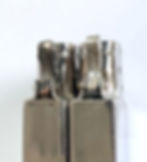 A piston cam spring (left) and the newer hump spring (right) on 14 hole chimney inserts. This transition took place in the year 1936.