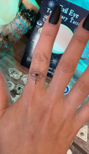 Evil eye finger temporary tattoo design close up 