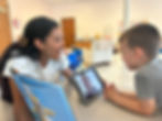 New Heights therapy conducting speech therapy at school with therapist and iPad