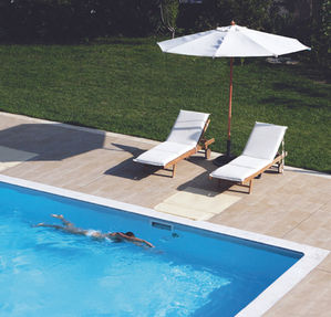 Swimming in pool with pool lounges