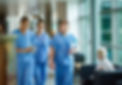 two male and one female medical professional in scrubs looking at a tablet used on a service page for a financial advisor for doctors and medical professionals