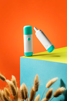 Minimalist product photography of health and wellness medical product floating in modern studio setting above allergens