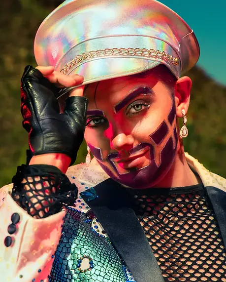 Lifestyle photography capturing drag performer in stylized fashion within a desert environment