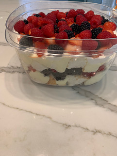 Summertime dessert with layers of angel food cake, berries and a custard in a to-go container