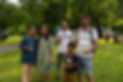 Happy family smiles while holding candles at park event