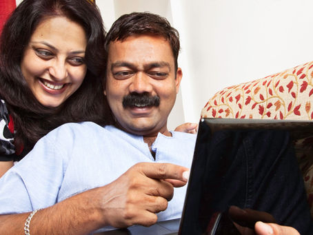 A smiling couple sitting together, having an open and warm conversation. The text overlay reads “How to Talk About Desires with Your Partner (Without Awkwardness)”