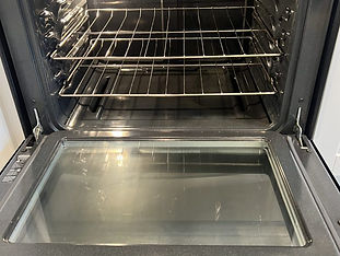 Interior of an oven thoroughly cleaned, free of grease and residue, shining like new.