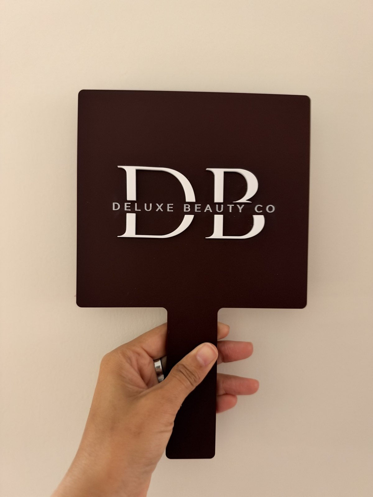 Rectangle handheld acrylic mirror with the DB logo