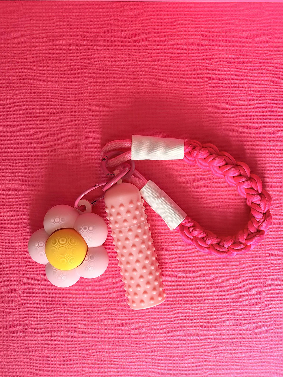 Pink dotted 3D printed lip balm cover on a braided keyring strap with a flower pot