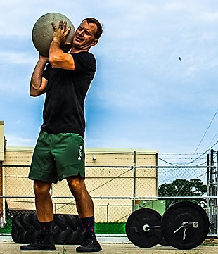 Coach Corey lifting a stone