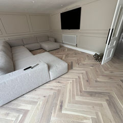 Border-free white oak herringbone floor flowing through a Victorian home in Hartford.