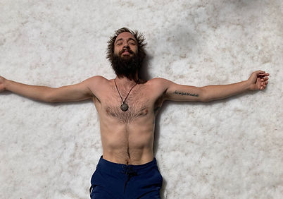 Javier lying down in the snow during cold exposure training