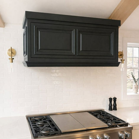 Custom dark blue range hood with handcrafted cabinetry and timeless kitchen design.