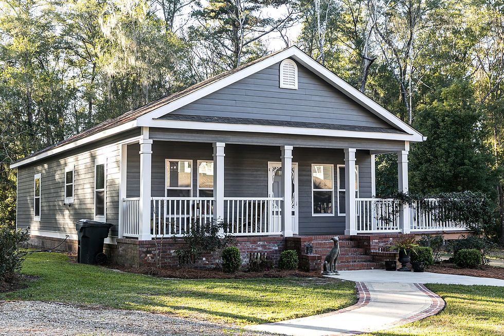 Blue-gray manufactured home with a covered porch and white railings