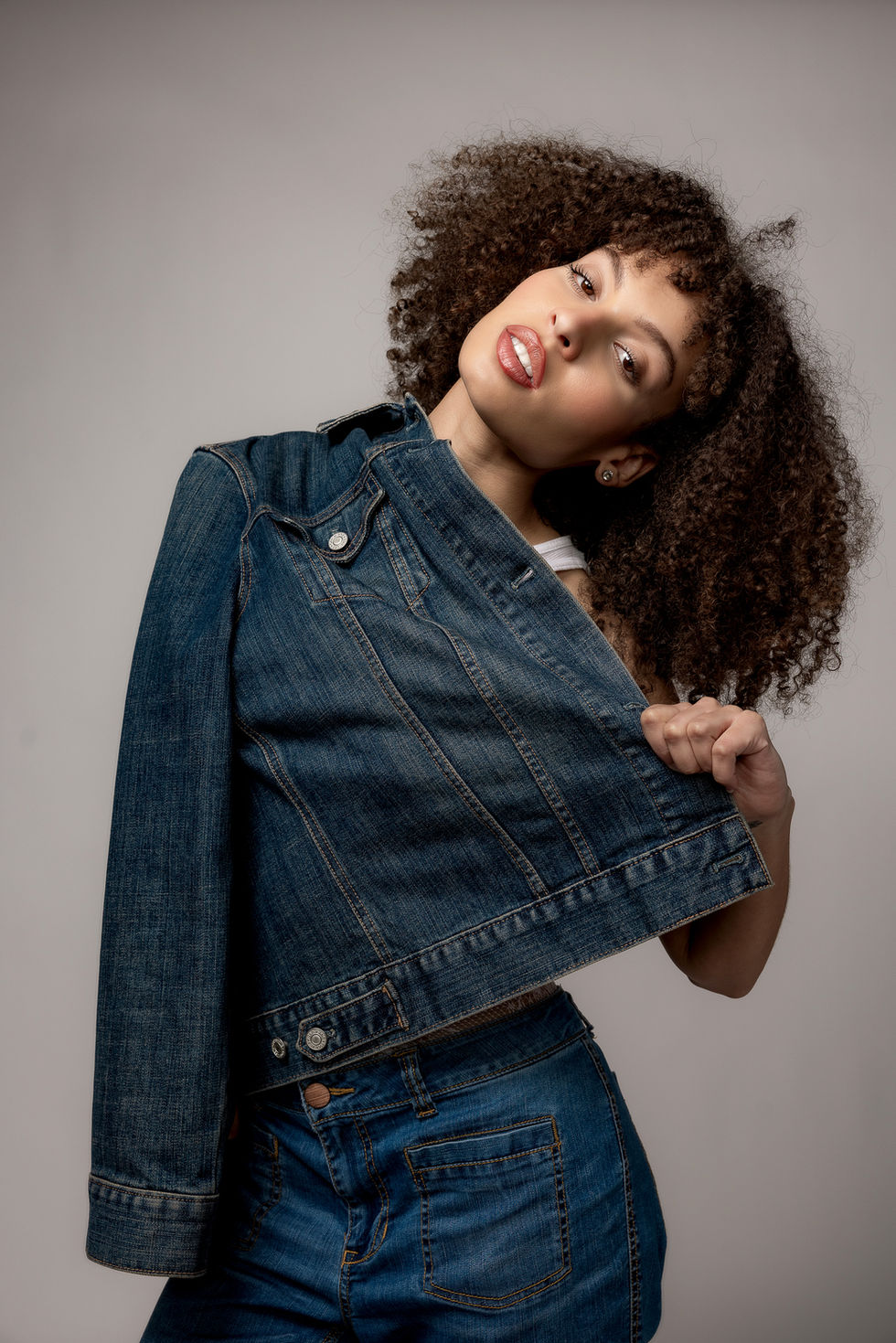 Commapix Fashion Portrait shots, Los Angeles — model in a cropped denim jacket, curls in motion, head tilted toward the camer