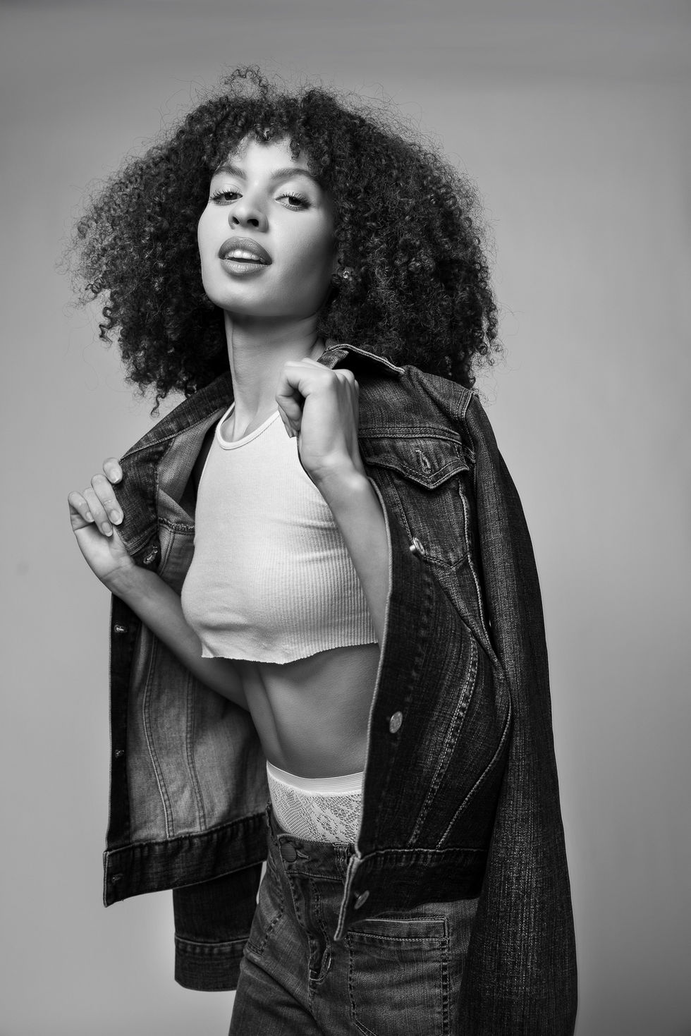 Commapix Fashion Portrait shots, DTLA — model in an open denim jacket and white crop top in a dynamic black-and-white pose.