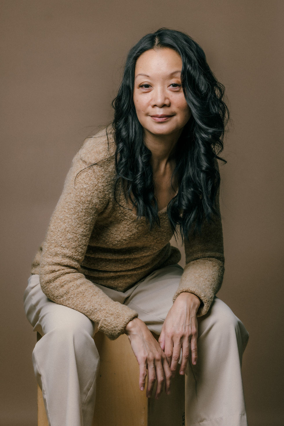 Emotional Portrait Studies by Commapix, DTLA — mature woman in tan knitwear seated with a gentle, natural smile.