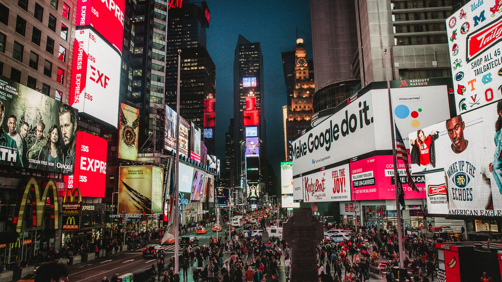 Times Square at night, glowing billboards and crowds, New York