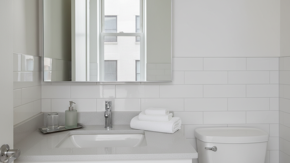 Eye-level view of a freshly cleaned bathroom vanity with a clear mirror and folded towels.