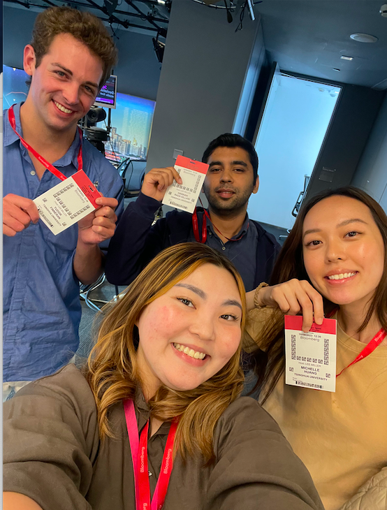 Tsinghua Global Business Journalism students show off their visitor badges during a visit to the Bloomberg News Beijing bureau.
