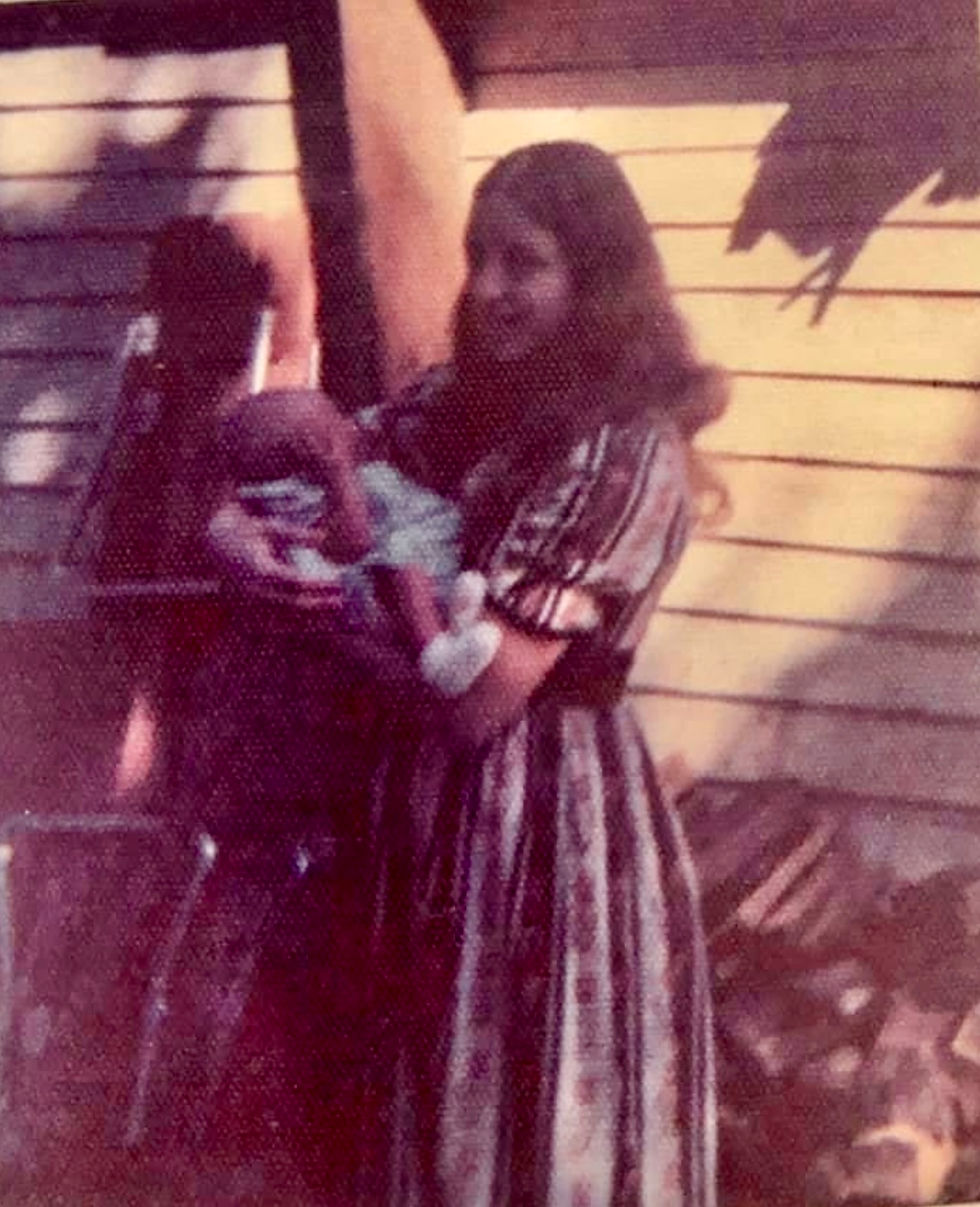 Woman holding a baby.