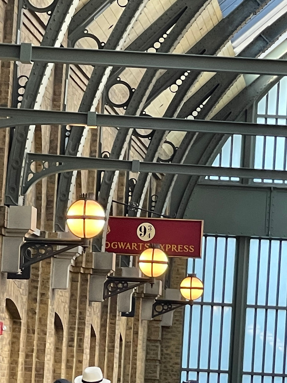 Sign at the train station that says 9 3/4 Hogwarts Express.