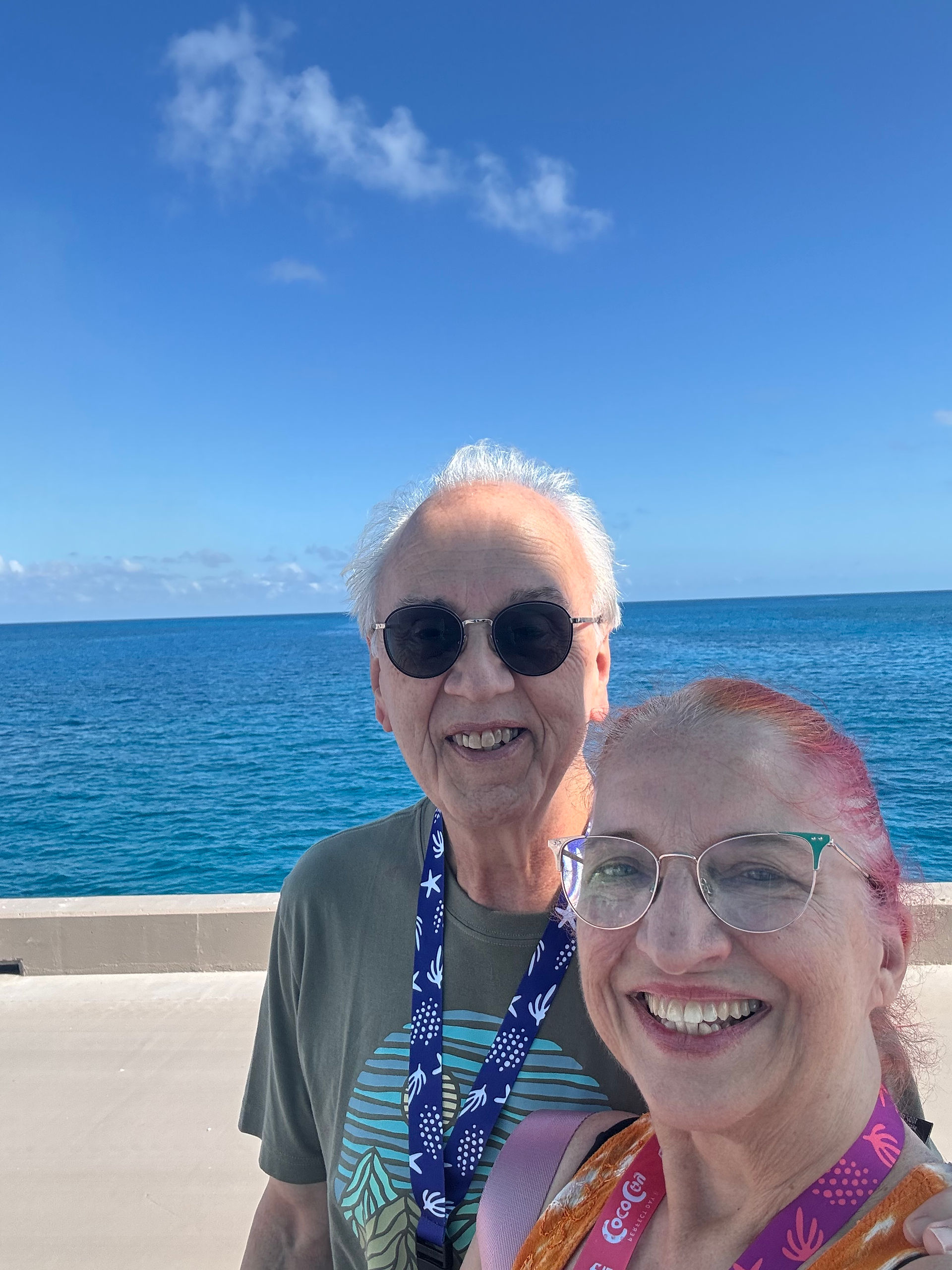 couple with the ocean behind them