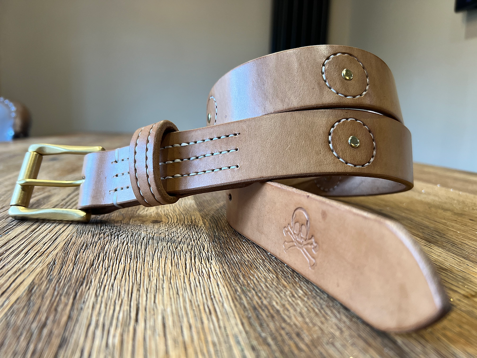Close-up view of a leatherworker hand-stitching a leather wallet