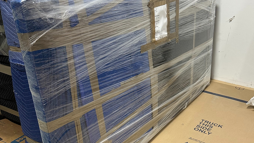 Items wrapped in blue blankets in the Positive Moves storage facility.