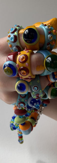 A handful of brightly coloured glass ings and beads