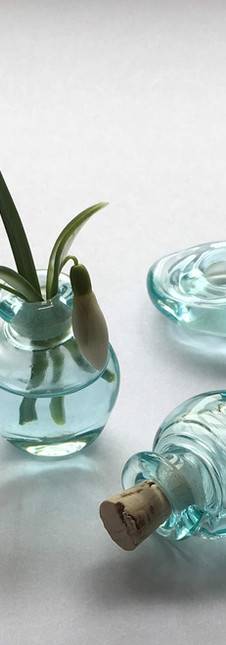 Two tiny, blueglass vessels and a disc