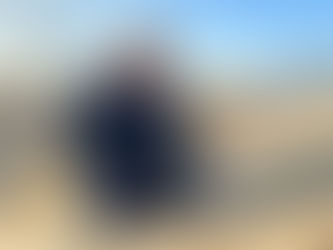 Eddie on rooftop inspecting shingles for a possible roof replacement