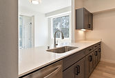 White quartz countertop with dark cabinets and undermount sink