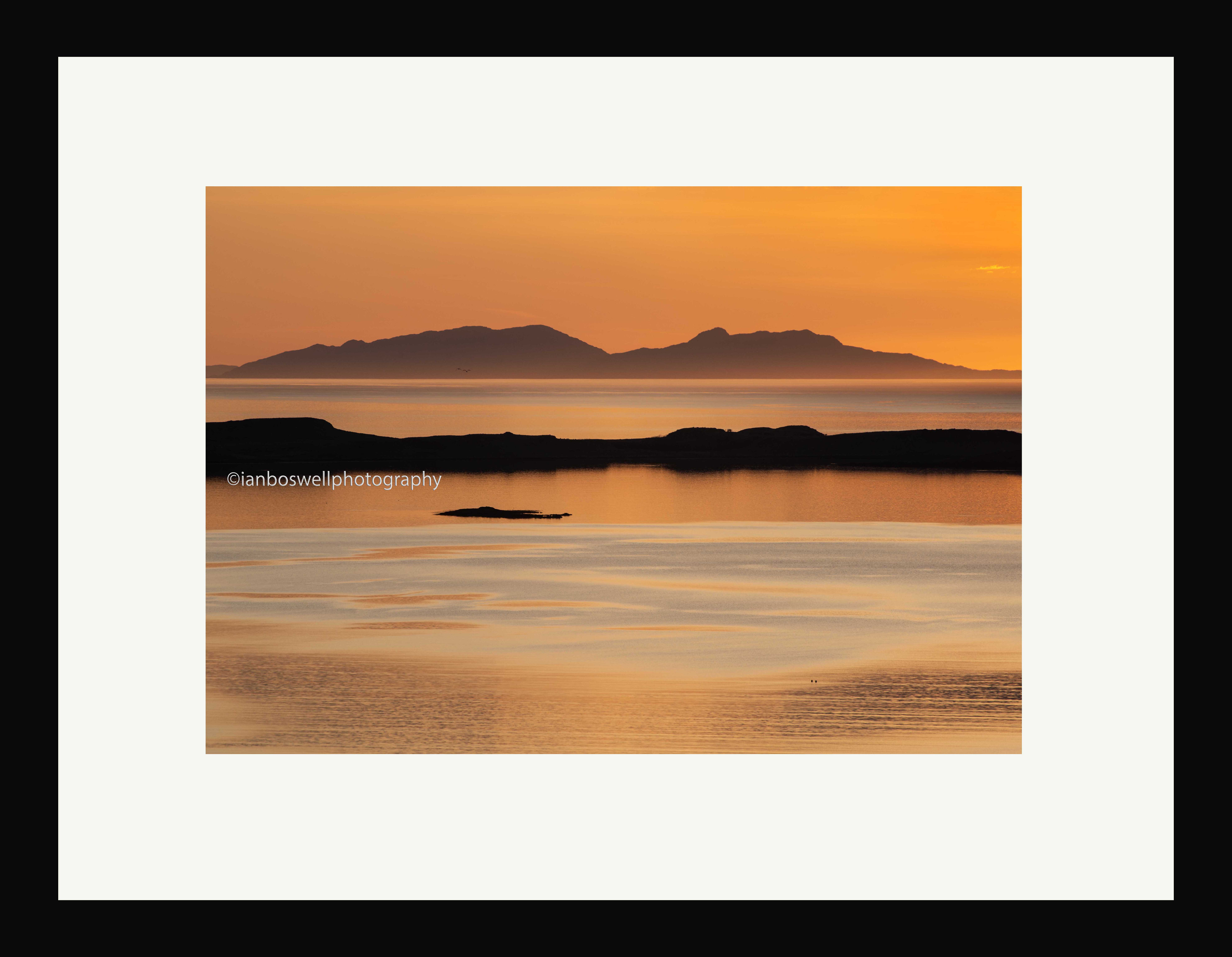sunset over iosaigh with north uist on the horizon (framed)