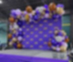 LSU themed balloon garland around purple backdrop that has tigers on the backdrop.