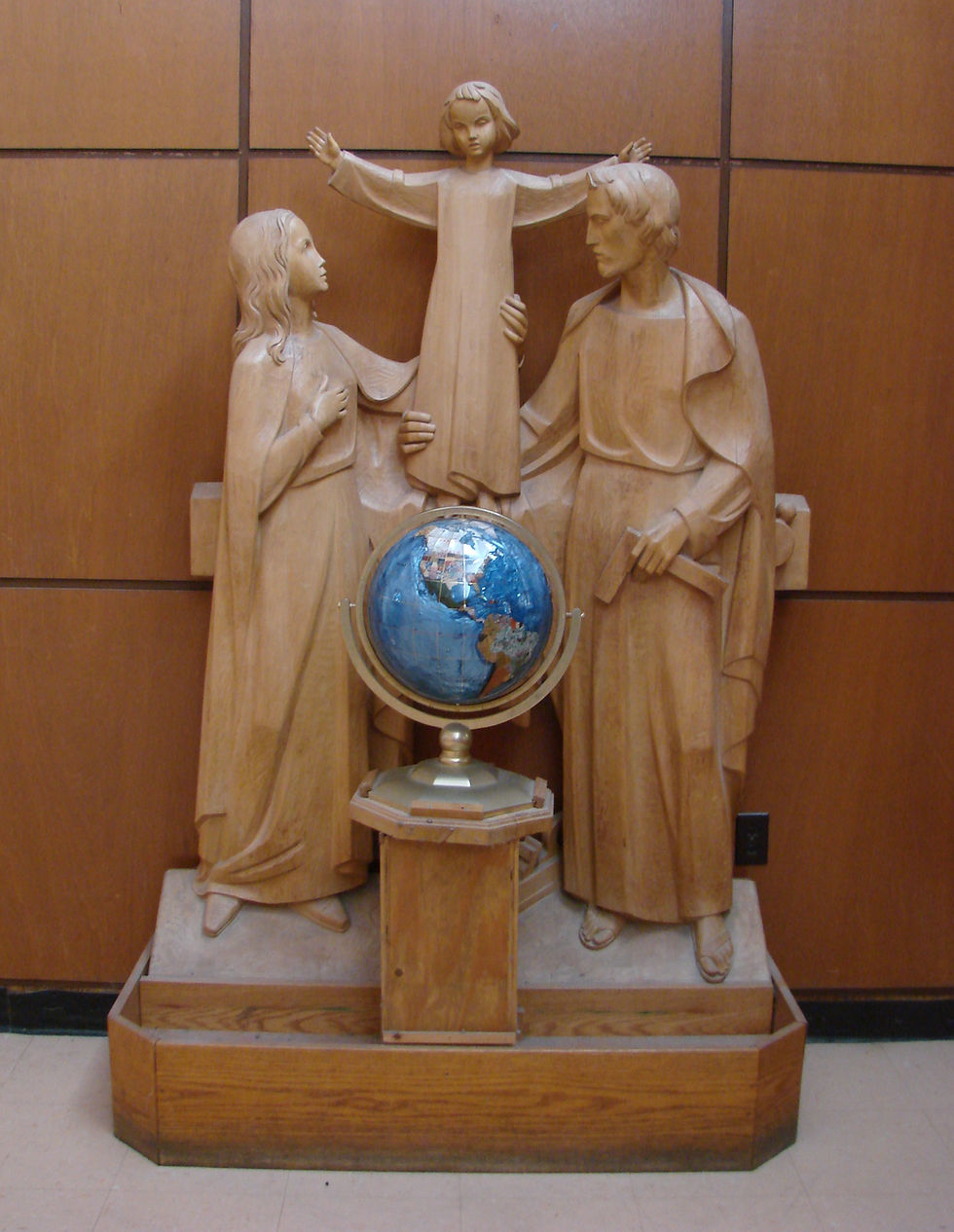 Mary, Joseph, Jesus behind a globe for religious education.