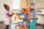 Smiling kids playing guitar, violin, flute in classroom at school.jpg