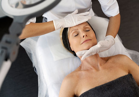 Top view of the pleasant beauty procedure with soft face massage performed by the professi