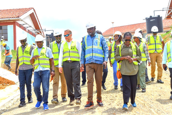 The World Bank support and project management unit team accessing progress at New Fulugani Primary School.  From Left, Chris Phelix Okoth and Martin Kungauiz from the Ministry of Education, Project Coordinator Eng Simon Kibachio, Pieter Waalewijn, WB, Project Manager engineer SAO Alima, Anne Bakilana, Ops Manager WB among others.