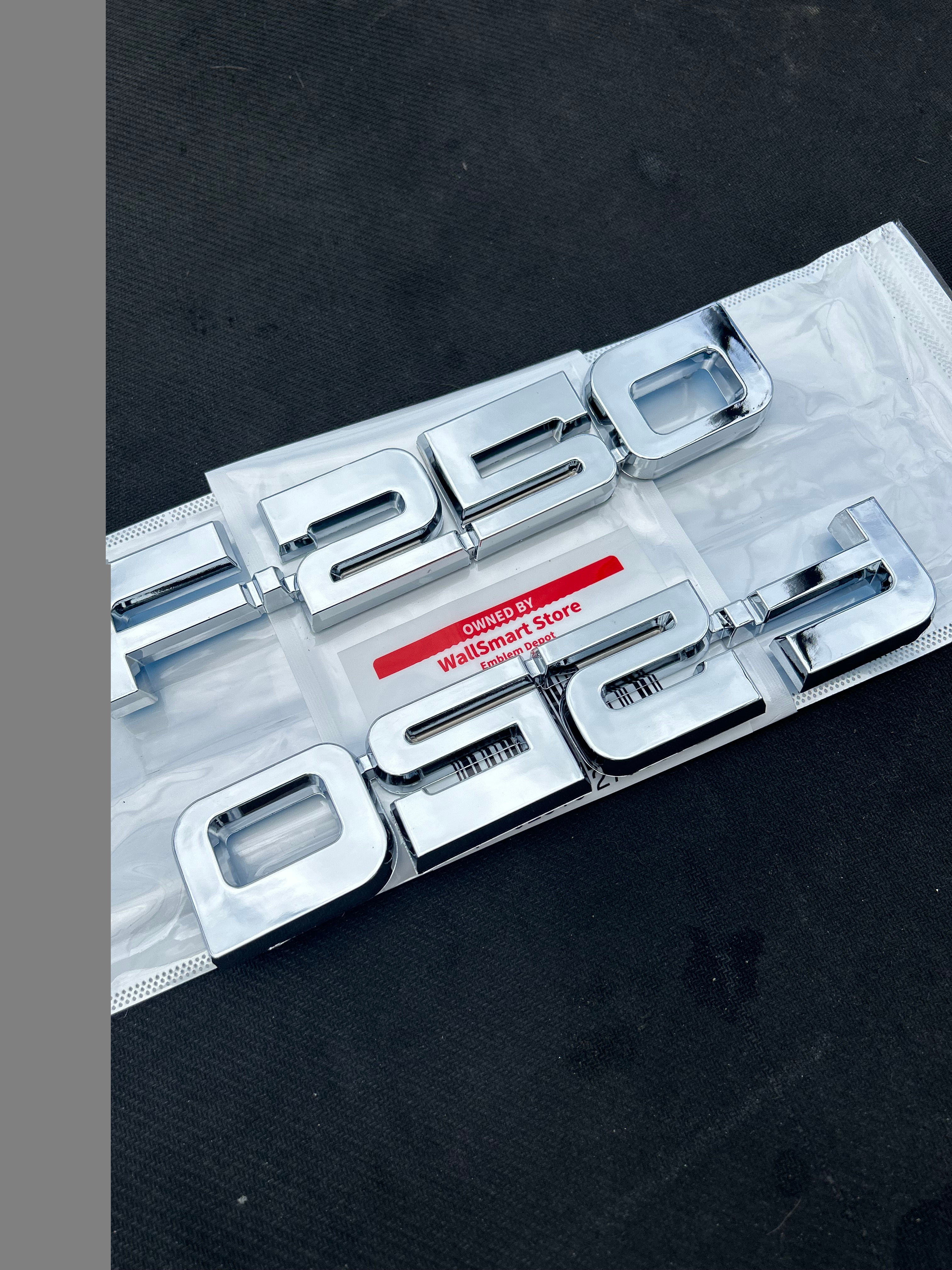 "1987-1991 Ford F-250 Silver Fender E7TZ-16720-B Nameplate Set displayed as a complete left and right pair."