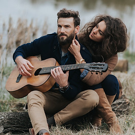 caucasian-man-is-playing-guitar-with-woman-by-the-2024-10-18-09-25-30-utc.jpg