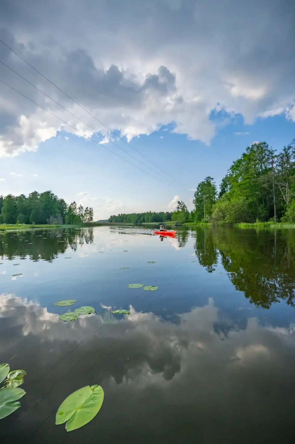 a person in a red kayak on a lake