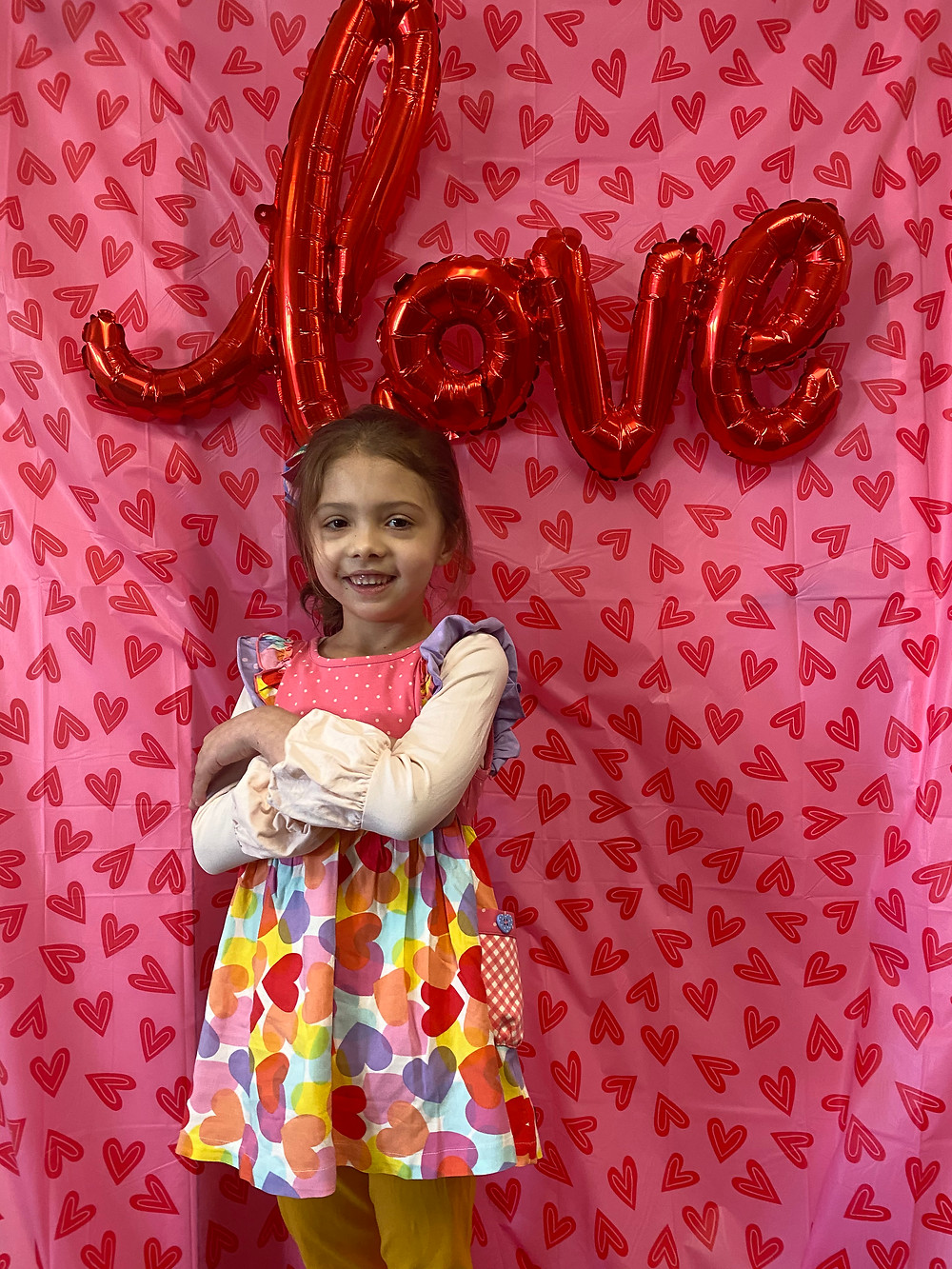 preschool student poses for Valentine's picture