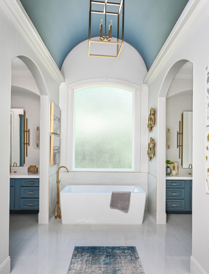 Master Bathroom design image of vanity with blue cabinetry and gold accented, geometric, modern mirror interior design, colorful bathroom in the Woodlands, TX - luxe interior design red award winner for 2024