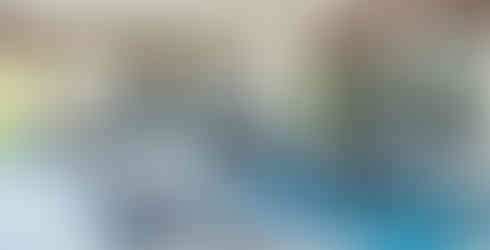 A backyard patio with outdoor kitchen, grill with a vent hood, fire pit, bar seating, dining table seating