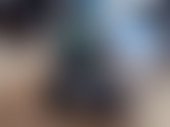 An older woman seated in an autonomous mobility vehicle inside an airport terminal, moving independently along the concourse. Other travelers and seating areas are visible in the background.